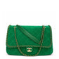 A green quilted suede shoulder bag with a silver-tone chain strap, shown from the back on a white background.