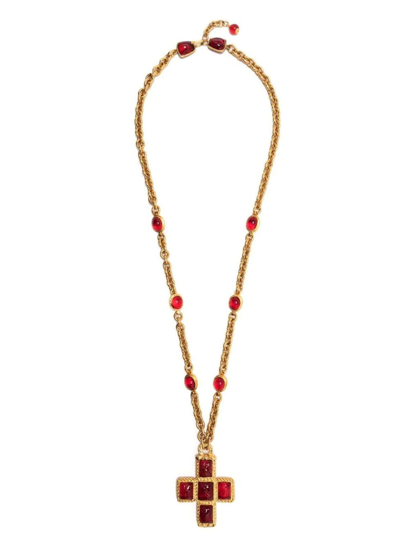 Chanel cross pendant necklace featuring a sleek silver cross hanging from a delicate chain. Elegant jewelry accessory.