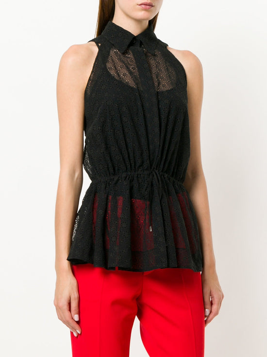 Black sheer broderie blouse by Alaïa, featuring intricate floral embroidery and lightweight, elegant sheer fabric.