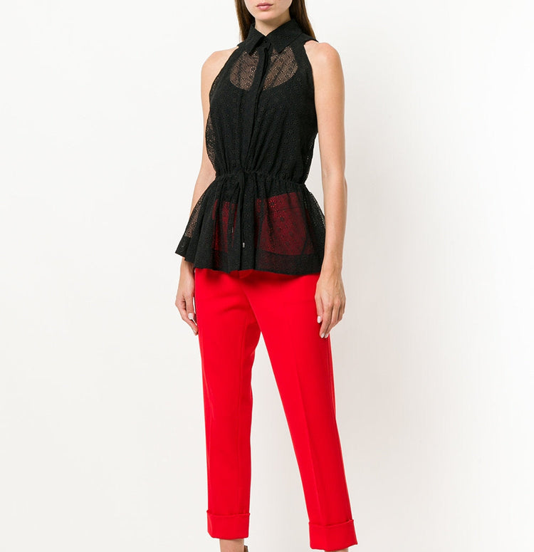 Black sheer broderie blouse by Alaïa, featuring delicate floral embroidery and lightweight, elegant design.