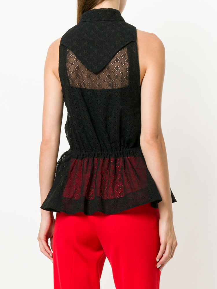 Black sheer broderie blouse by Alaïa, featuring delicate floral embroidery, long sleeves, and a lightweight, elegant design.
