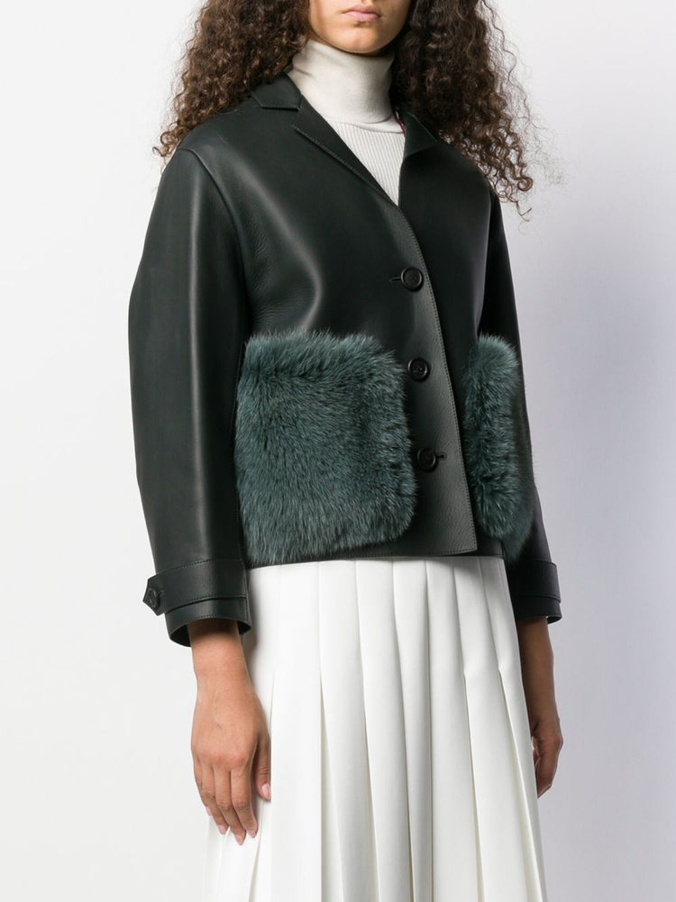 Burberry Prorsum black leather jacket with collar, button-front fastening, cropped silhouette, long sleeves, and oversized fur-trimmed front patch pockets.