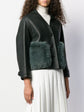 Burberry Prorsum black leather jacket with collar, button-front fastening, cropped silhouette, long sleeves, and oversized fur-trimmed front patch pockets.