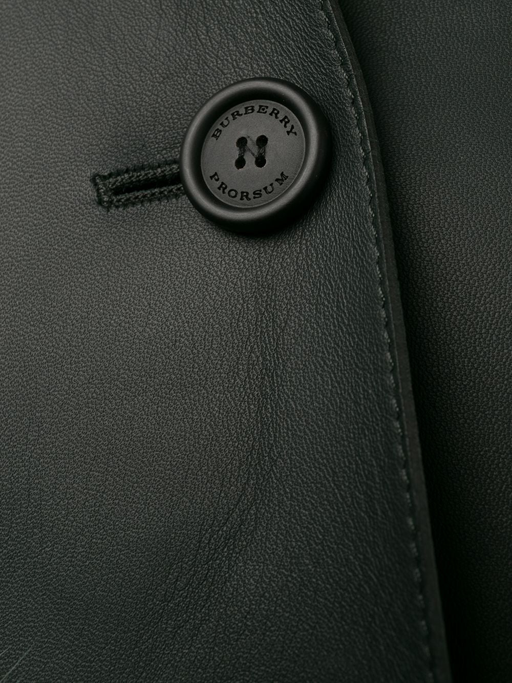 Burberry Prorsum black leather jacket with collar, button-front fastening, cropped silhouette, long sleeves, and oversized fur-trimmed front patch pockets.