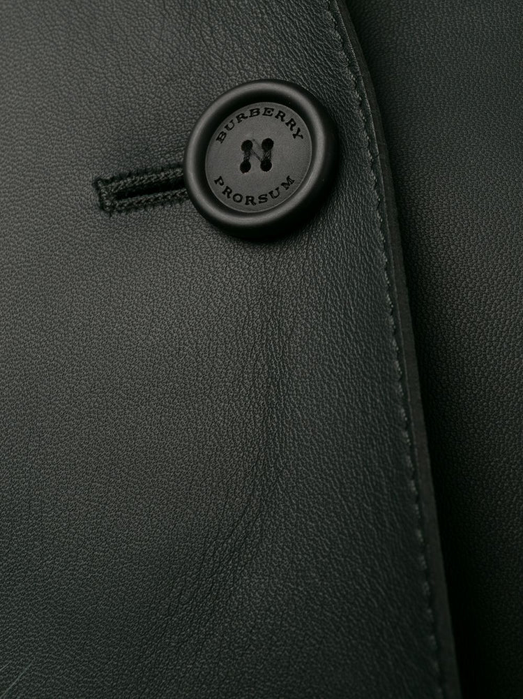 Burberry Prorsum black leather jacket with collar, button-front fastening, cropped silhouette, long sleeves, and oversized fur-trimmed front patch pockets.