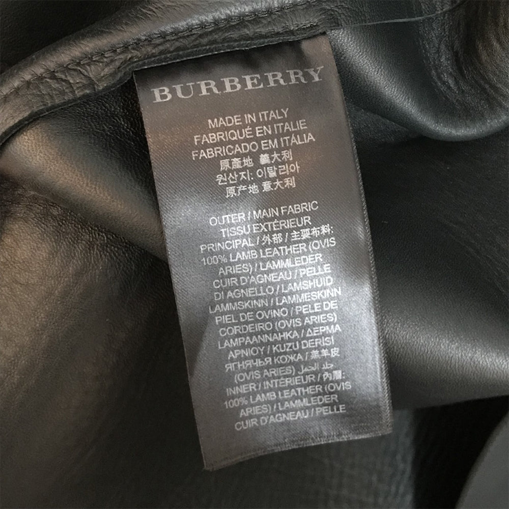 Burberry Prorsum black leather jacket with collar, button-front fastening, cropped silhouette, long sleeves, and oversized fur-trimmed front patch pockets.
