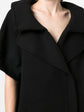Black Chanel short-sleeved knit gilet, stylish blazer or jacket, featuring a sleek design and textured fabric.