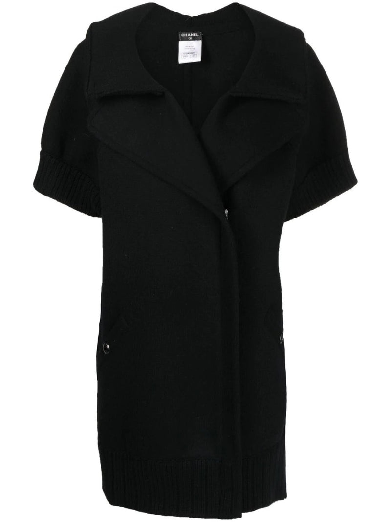 Black Chanel short-sleeved knit gilet, stylish blazer and jacket hybrid, featuring a sleek design and classic Chanel detailing.