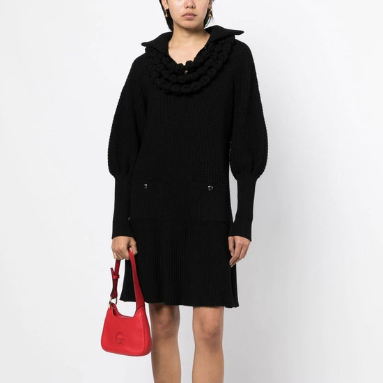 Chanel black textured knit dress with oversized pointed collar, sculptural looped neckline detailing, long blouson sleeves, front patch pockets and ribbed flared hem.