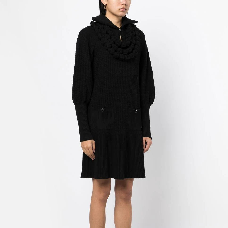 Black textured knit Chanel dress with a collar, showcasing elegant, classic design perfect for sophisticated occasions.
