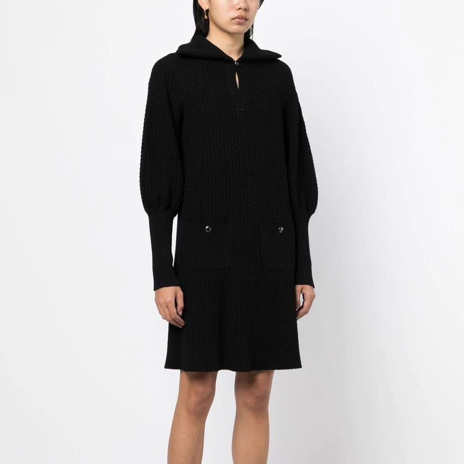 Black Chanel knit collared dress with textured fabric, tailored fit, and classic design, perfect for elegant occasions.