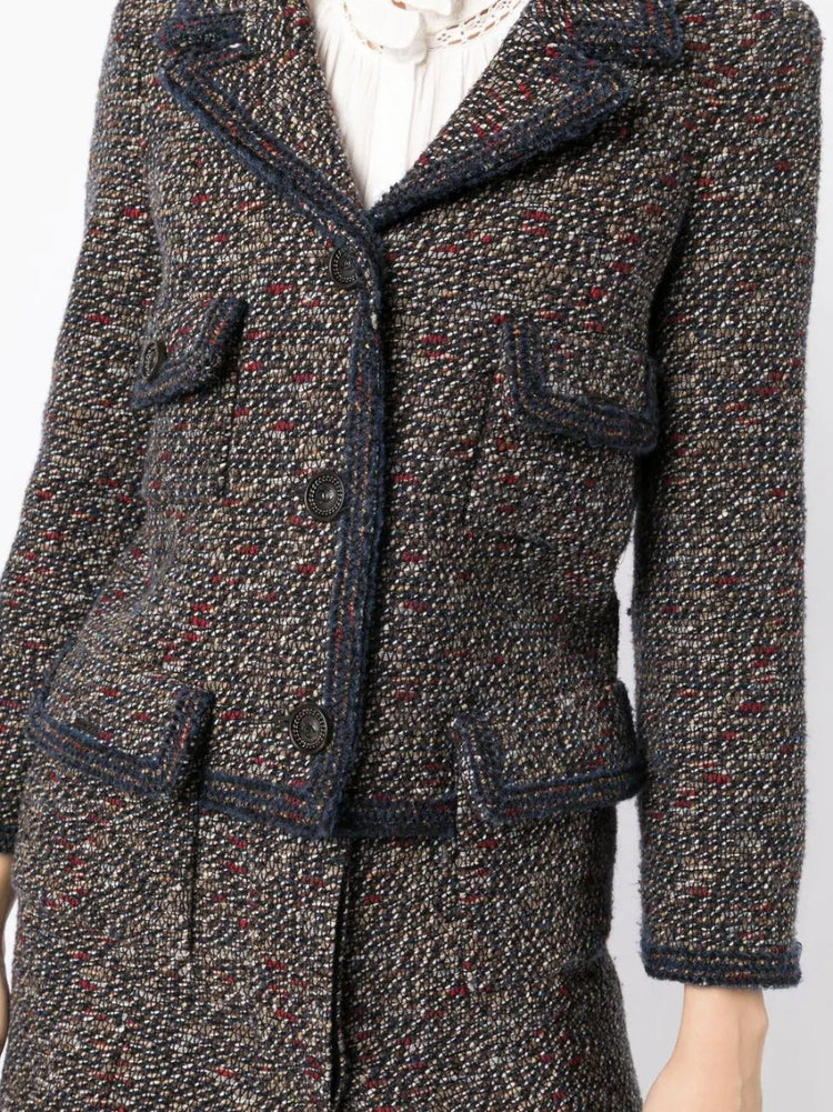 Chanel layered tweed jacket featuring classic collar, structured fit, and textured fabric, styled as a blazer or jacket.