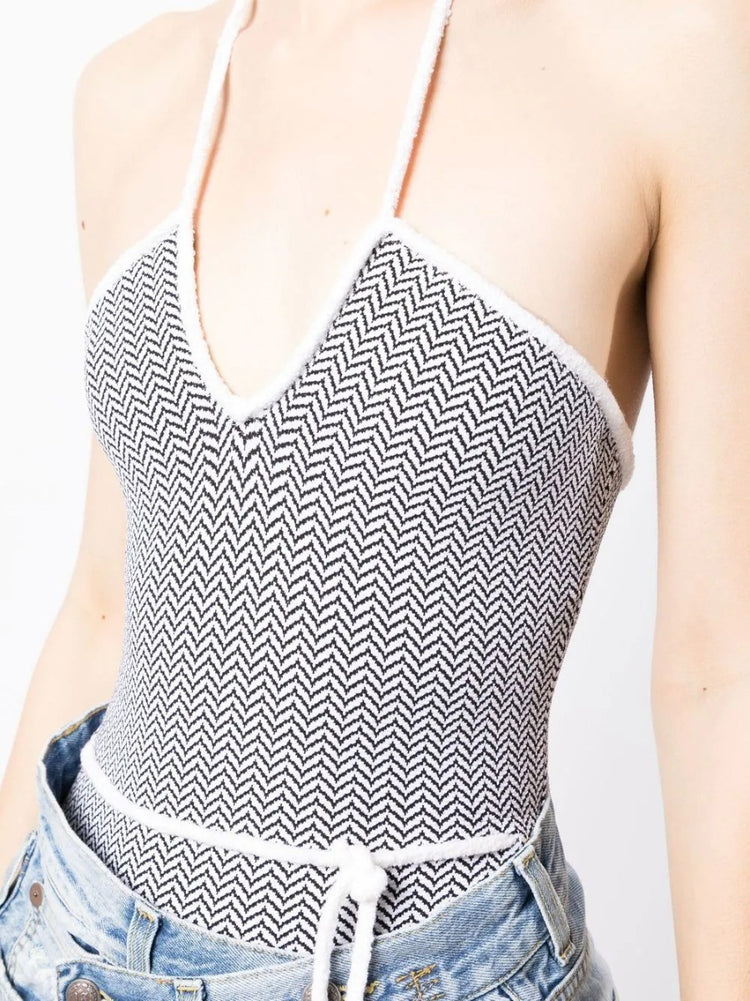 White and black chevron patterned Chanel halterneck swimsuit, stylish swimwear with a sophisticated design.