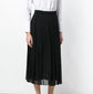 Black Gucci pleated skirt with a high waist and flowing pleats, styled as a chic fashion piece for women.