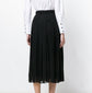 Black Gucci pleated skirt with sharp, evenly spaced pleats, stylish and elegant, shown on a model against a neutral background.