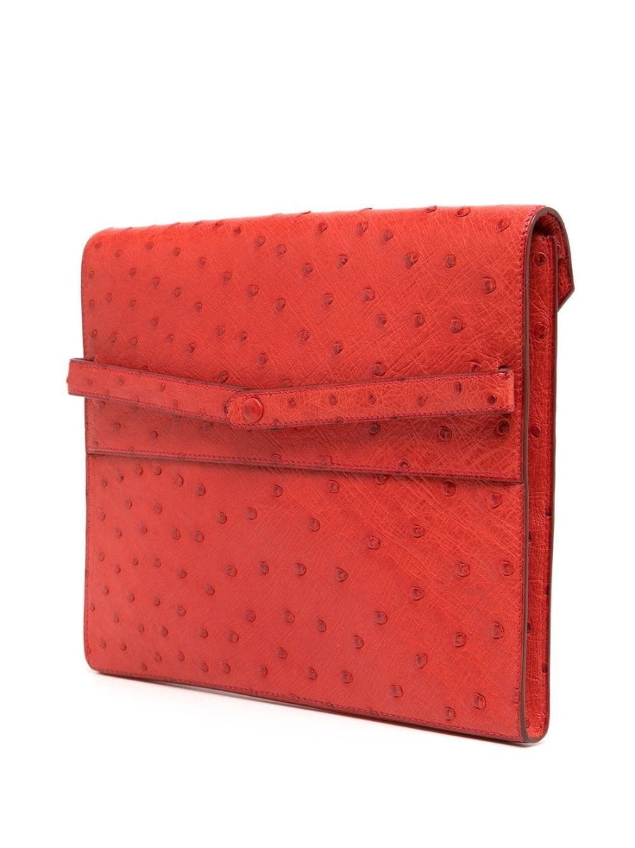 Hermès Red Ostrich Liddy Clutch Bag with envelope-style fold-over shape, vibrant red exotic leather, ostrich quill texture and minimalist structured silhouette.