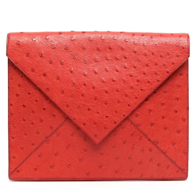 Hermès Red Ostrich Liddy Clutch Bag with envelope-style fold-over shape, vibrant red exotic leather, ostrich quill texture and minimalist structured silhouette.