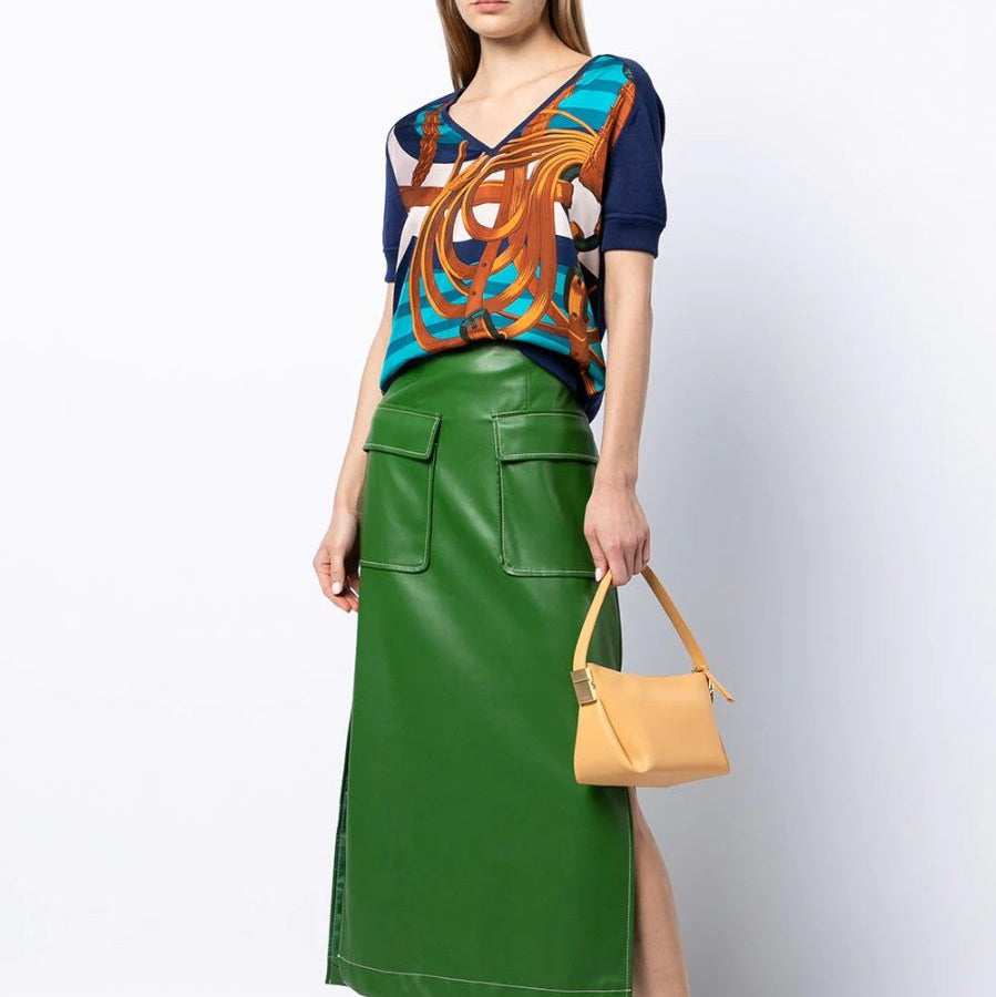 Hermès navy bridle print silk top displayed on a hanger, showcasing elegant pattern and smooth fabric in a stylish women&