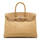 Hermès Birkin 35 bag in Parchemin beige Porosus crocodile leather with dual rolled handles, palladium-tone hardware, front flap, belted straps, and turn-lock closure.