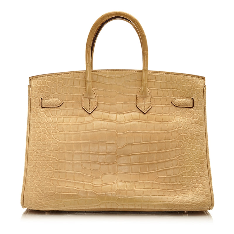 Hermès Birkin 35 bag in Parchemin beige Porosus crocodile leather with dual rolled handles, palladium-tone hardware, front flap, belted straps, and turn-lock closure.