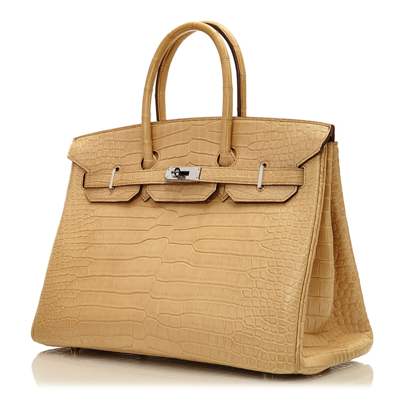 Hermès Birkin 35 bag in Parchemin beige Porosus crocodile leather with dual rolled handles, palladium-tone hardware, front flap, belted straps, and turn-lock closure.