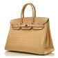 Hermès Birkin 35 bag in Parchemin beige Porosus crocodile leather with dual rolled handles, palladium-tone hardware, front flap, belted straps, and turn-lock closure.