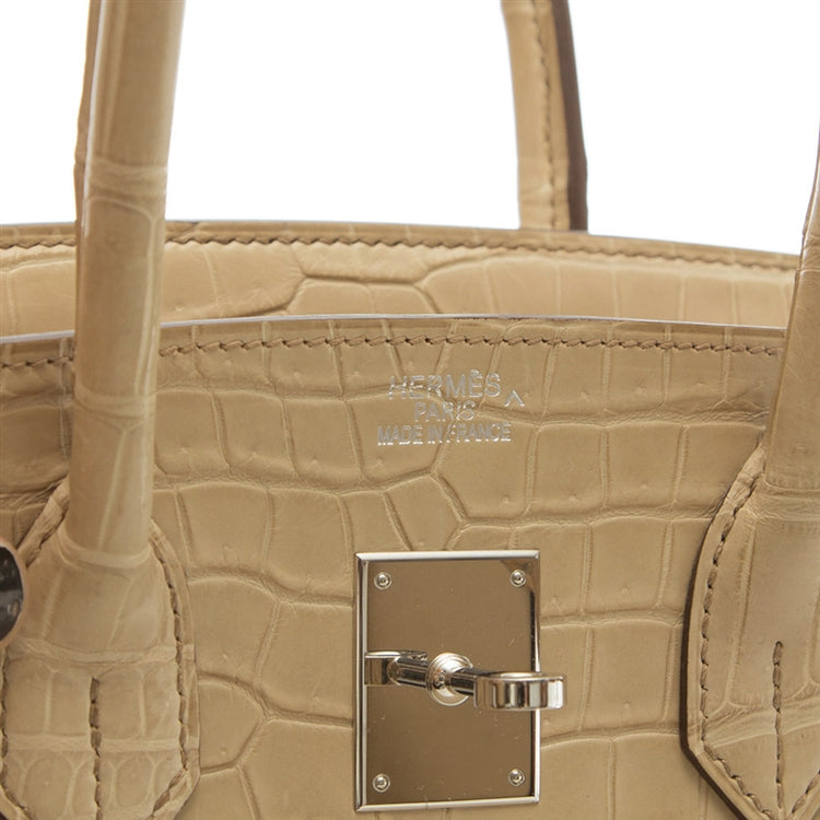 Hermès Birkin 35 bag in Parchemin beige Porosus crocodile leather with dual rolled handles, palladium-tone hardware, front flap, belted straps, and turn-lock closure.