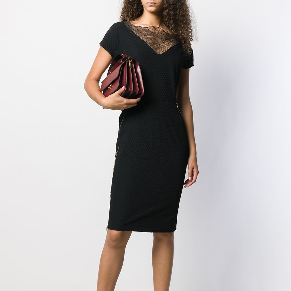 Black Nina Ricci shift dress with a sleek, minimalist design, showcasing smooth fabric and a classic silhouette.