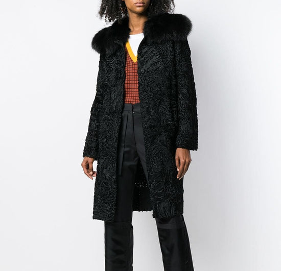 Prada black jacquard Astrakhan coat featuring textured fabric and classic tailored design, displayed on a hanger.