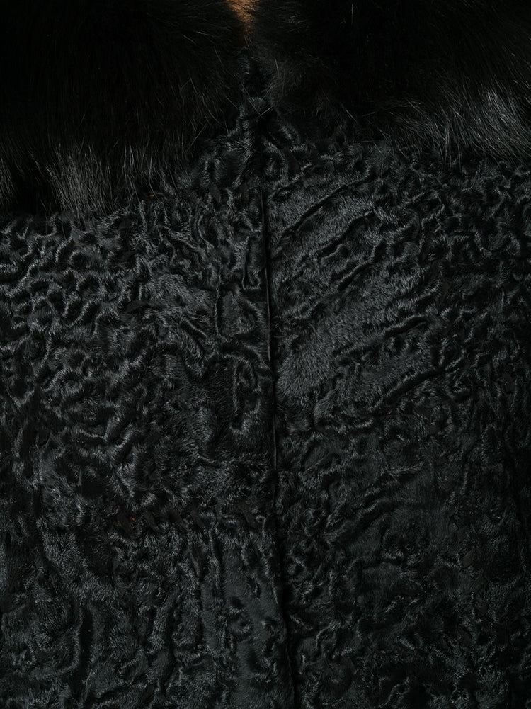 Prada black jacquard Astrakhan coat featuring textured fabric, tailored fit, and classic collar detail, displayed on a hanger.
