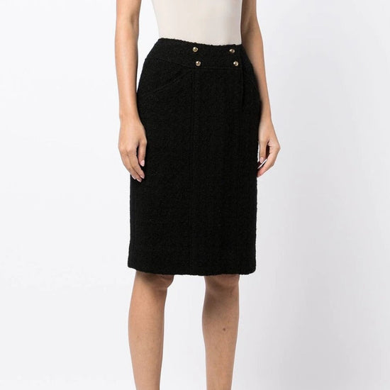 Chanel tweed pencil skirt with high waist and tailored fit, featuring classic plaid pattern and elegant design.