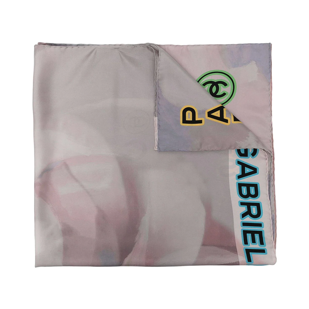 Chanel Camellia motif silk scarf featuring elegant floral design and vibrant colors, displayed flat on a neutral background.