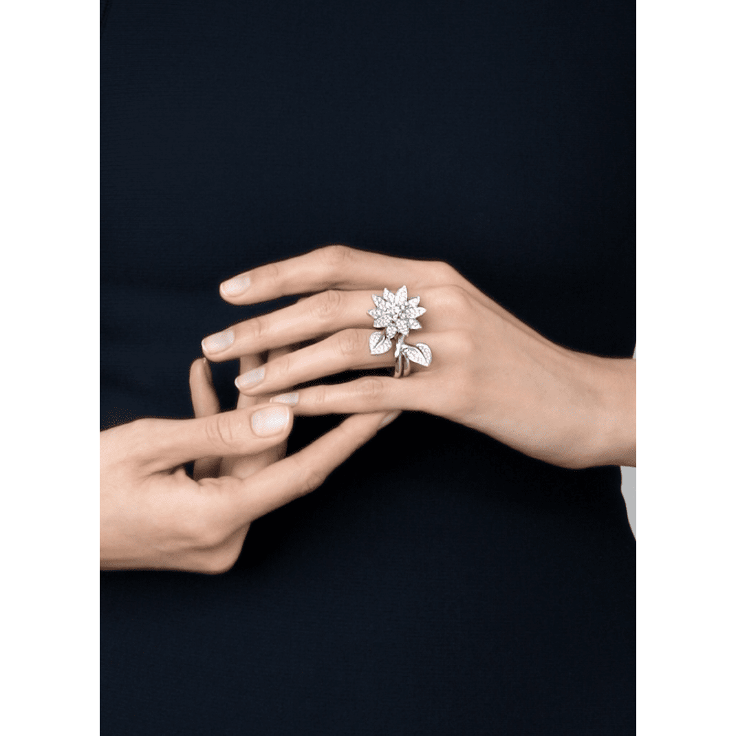 Elegant Van Cleef & Arpels diamond lotus between the finger ring showcasing intricate design and sparkling diamonds.