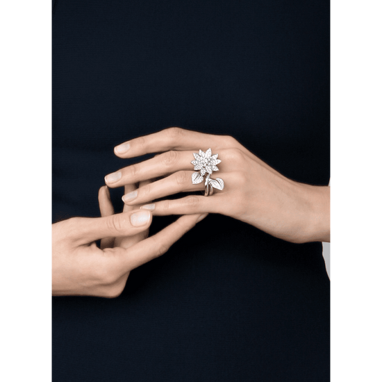 Elegant Van Cleef & Arpels diamond lotus between the finger ring showcasing intricate design and sparkling diamonds.
