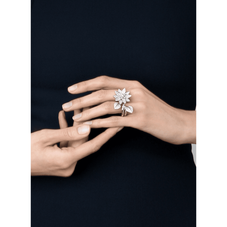 Elegant Van Cleef & Arpels diamond lotus between the finger ring showcasing intricate design and sparkling diamonds.