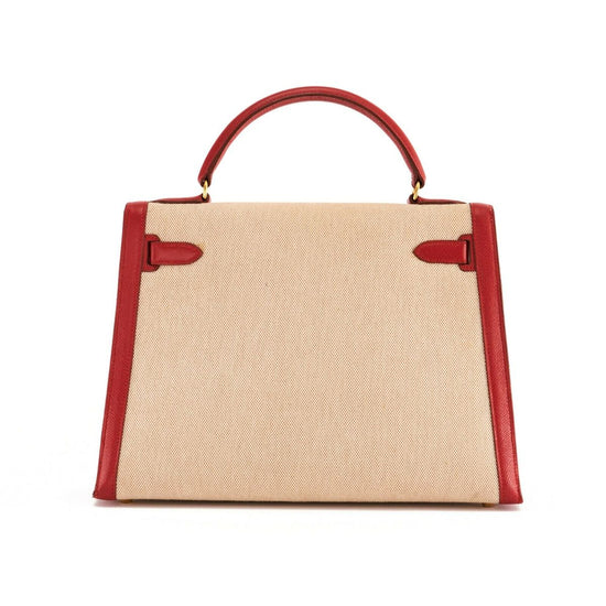 Hermès Kelly 32 Rouge Toile GHW top handle bag with gold hardware, showcasing its elegant leather design and structured silhouette.